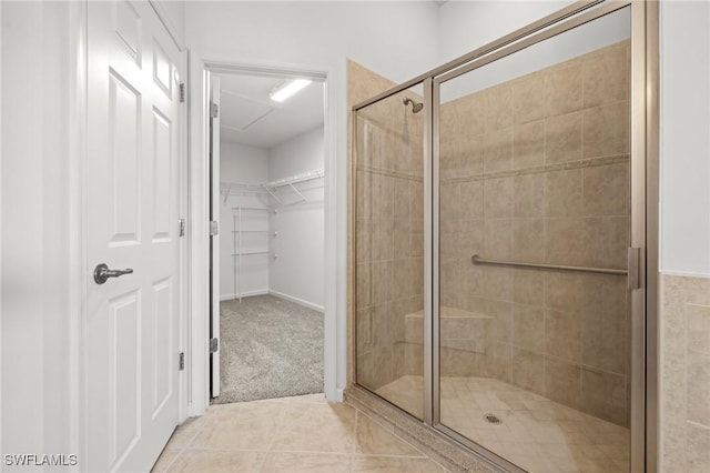 bathroom featuring tile patterned flooring and an enclosed shower