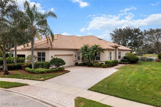 view of front of home with a garage and a front lawn