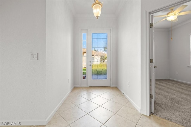 doorway to outside featuring ceiling fan, ornamental molding, and light tile patterned floors