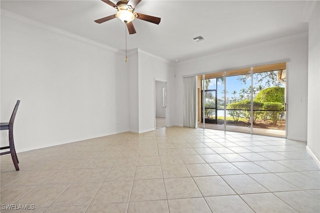 tiled spare room featuring crown molding and ceiling fan