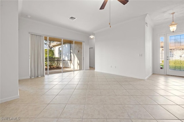 spare room with light tile patterned floors, baseboards, visible vents, and crown molding