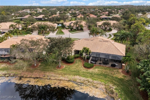 bird's eye view featuring a water view and a residential view