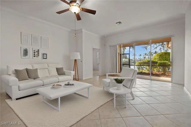 living area featuring crown molding, light tile patterned floors, visible vents, a ceiling fan, and baseboards