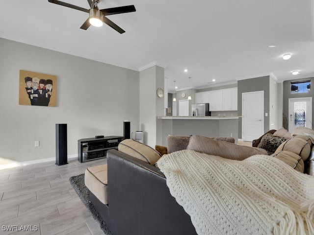 living room with crown molding and ceiling fan