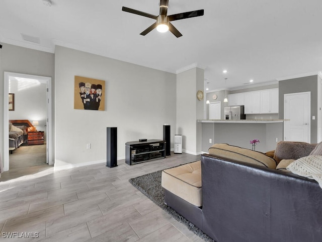 living room with ornamental molding and ceiling fan