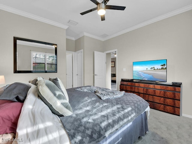 carpeted bedroom with ornamental molding and ceiling fan