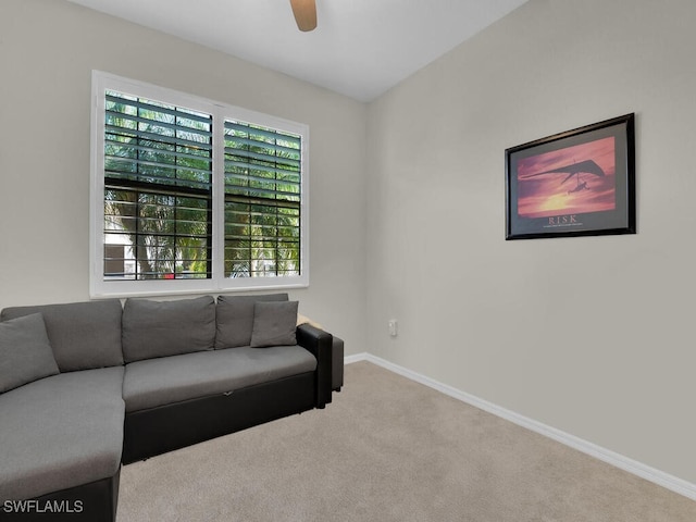 carpeted living room featuring ceiling fan