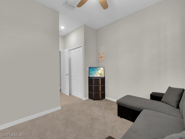 carpeted living room featuring ceiling fan