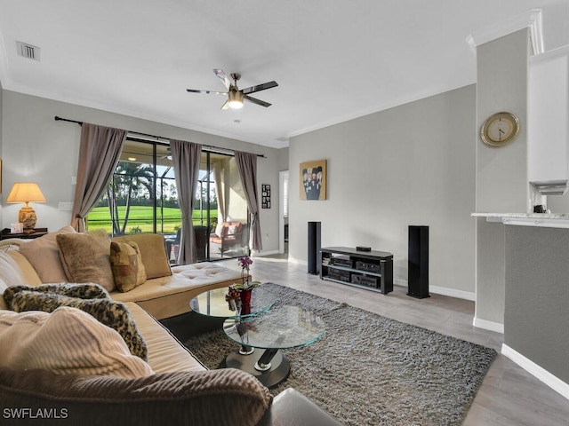 living room featuring ornamental molding and ceiling fan