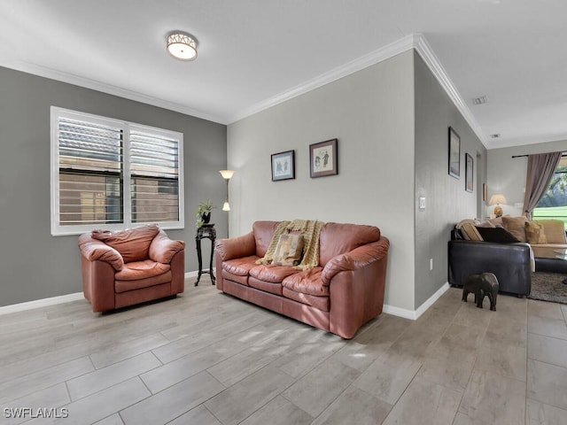 living room with ornamental molding and light hardwood / wood-style floors