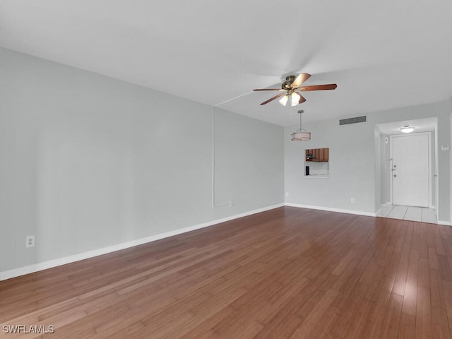 spare room featuring ceiling fan and light hardwood / wood-style floors