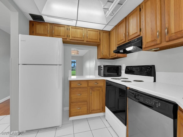 kitchen featuring stainless steel dishwasher, light tile patterned floors, white fridge, and range with electric stovetop