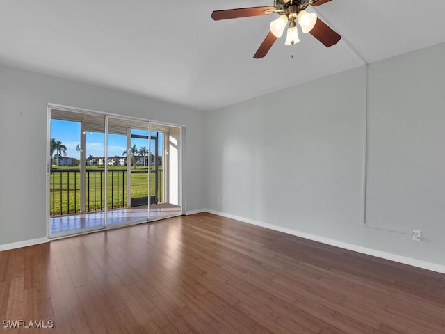 empty room with ceiling fan and hardwood / wood-style floors