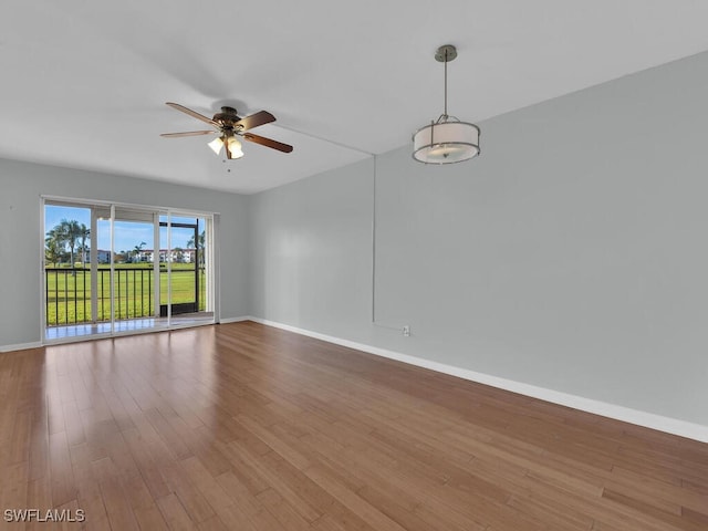 spare room with hardwood / wood-style flooring and ceiling fan