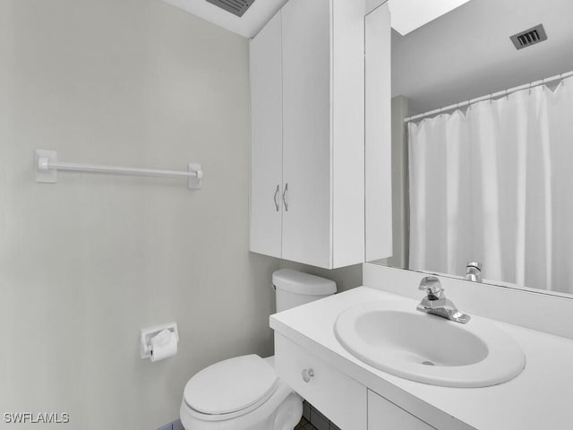 bathroom featuring vanity and toilet