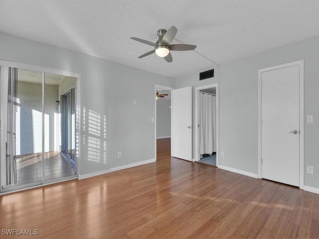 empty room with wood-type flooring and ceiling fan