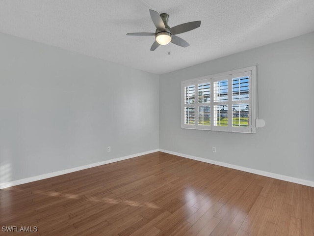 unfurnished room featuring ceiling fan, wood-type flooring, and a textured ceiling