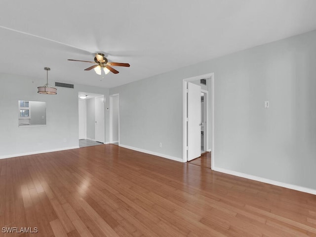 spare room with hardwood / wood-style floors and ceiling fan