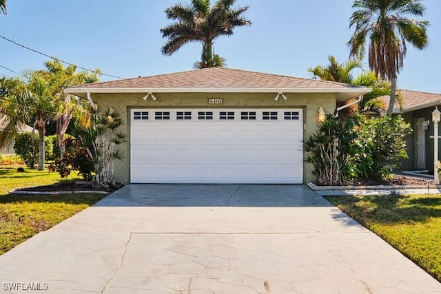 view of front of house with a garage and a front lawn