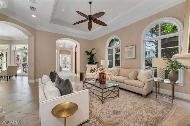 455 1st Ave N, Naples, FL 34102 - living area featuring arched walkways, ceiling fan, light tile patterned floors, a raised ceiling, and crown molding