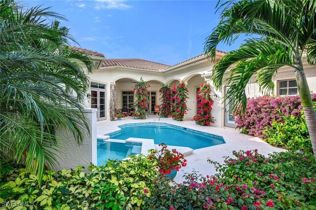 455 1st Ave N, Naples, FL 34102 - view of swimming pool featuring a patio and a pool with connected hot tub