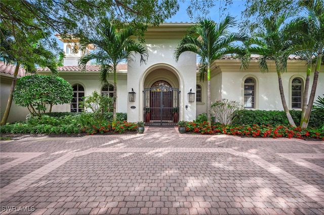 view of front of home featuring a tiled roof and stucco siding