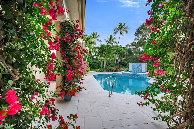 outdoor pool with a patio area