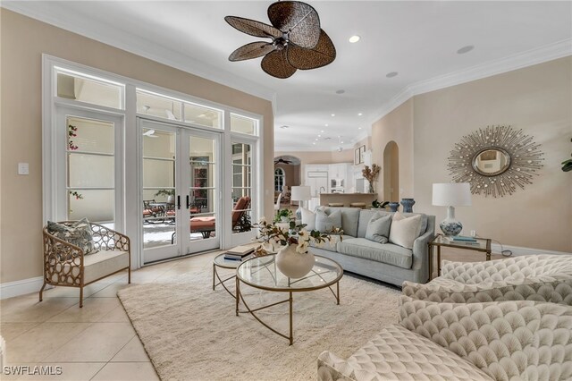 455 1st Ave N, Naples, FL 34102 - living room featuring arched walkways, ceiling fan, crown molding, light tile patterned floors, and baseboards