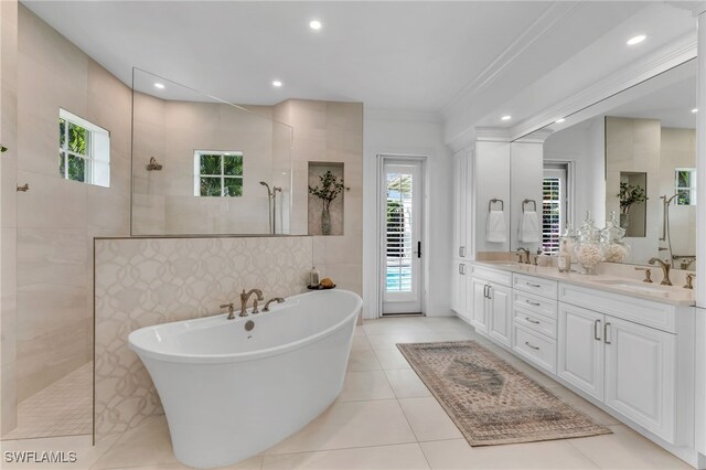 455 1st Ave N, Naples, FL 34102 - bathroom with a walk in shower, double vanity, a freestanding tub, ornamental molding, and tile patterned floors