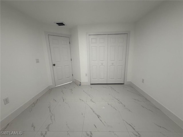 unfurnished bedroom with a closet