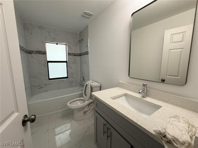 full bathroom featuring vanity, toilet, and tiled shower / bath