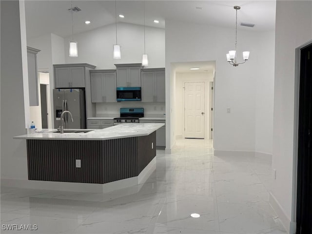 kitchen with sink, gray cabinets, stainless steel appliances, high vaulted ceiling, and decorative light fixtures