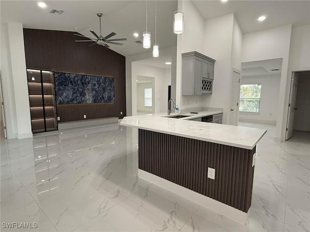 kitchen featuring sink, hanging light fixtures, high vaulted ceiling, and kitchen peninsula