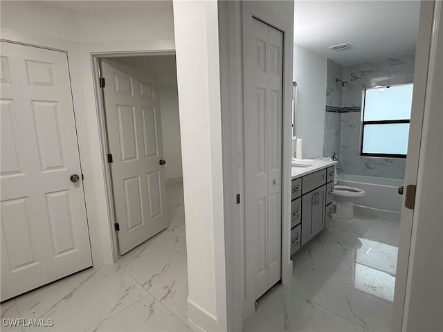 full bathroom with vanity, tiled shower / bath combo, and toilet