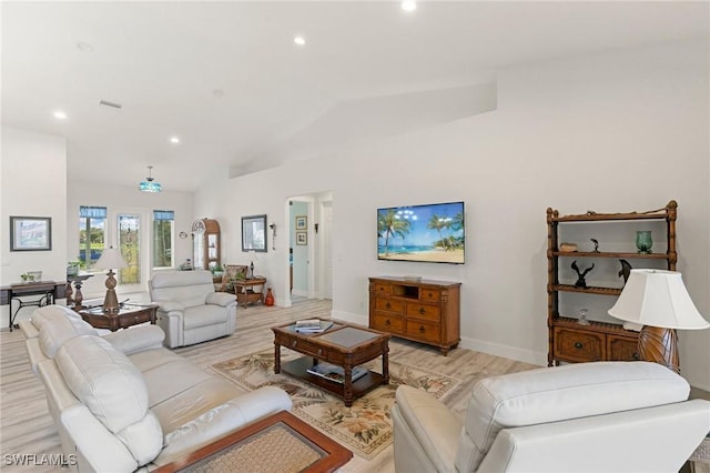 living room with vaulted ceiling and light hardwood / wood-style floors