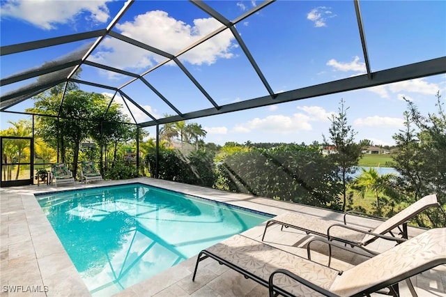 view of pool with a patio and glass enclosure