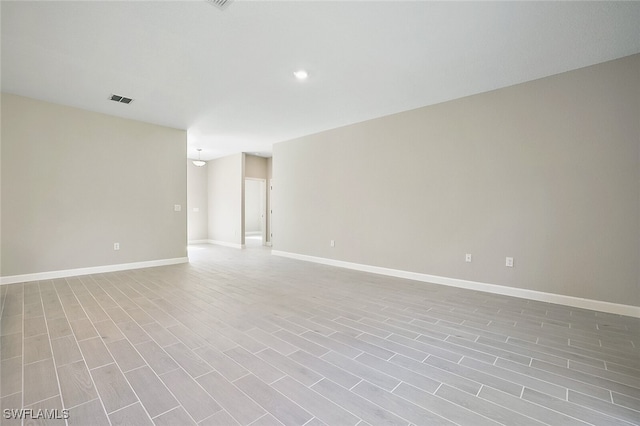 spare room with light hardwood / wood-style flooring