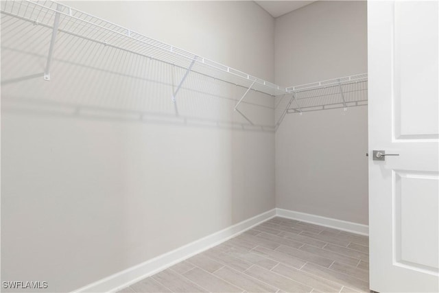 walk in closet featuring light hardwood / wood-style flooring