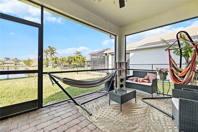 sunroom featuring ceiling fan