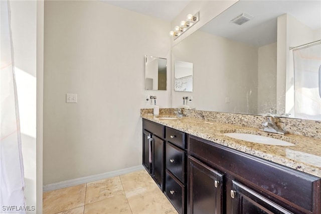 bathroom with double vanity, tile patterned flooring, a sink, and visible vents