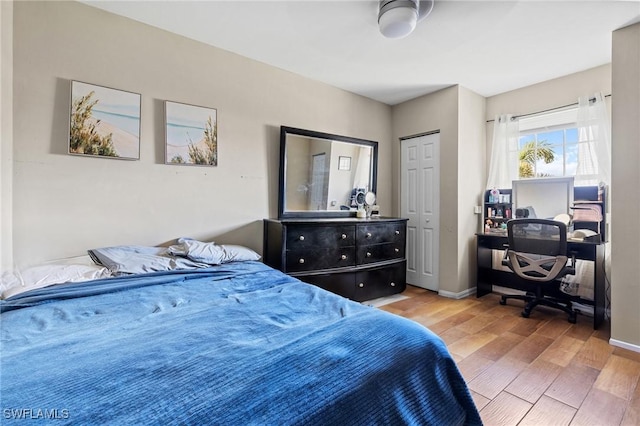 bedroom featuring baseboards and wood finished floors