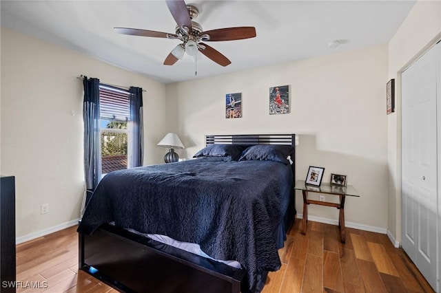 bedroom featuring ceiling fan, wood finished floors, and baseboards