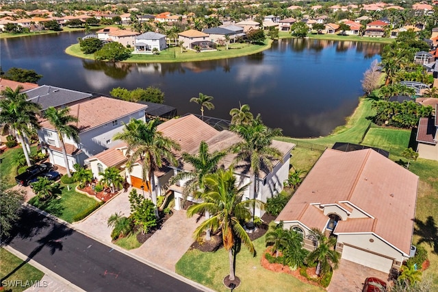 drone / aerial view featuring a water view and a residential view