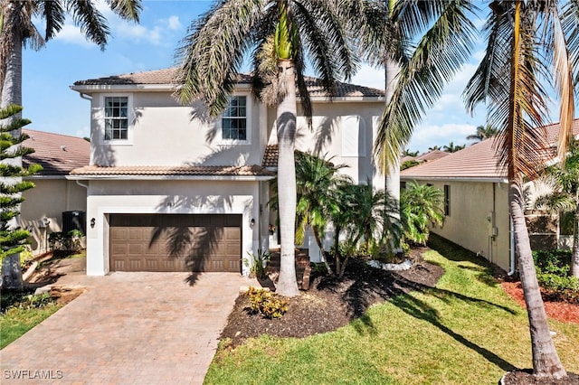 mediterranean / spanish home with a garage and a front yard