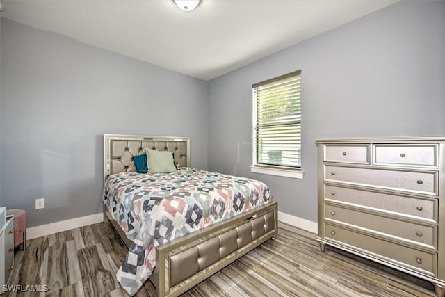 bedroom with hardwood / wood-style flooring