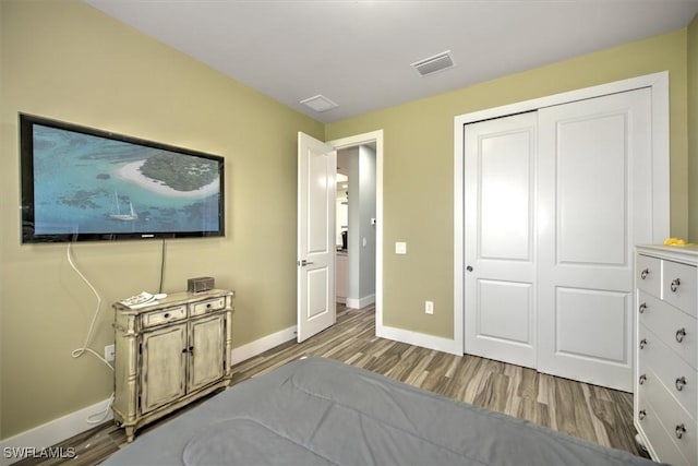 bedroom featuring wood-type flooring and a closet