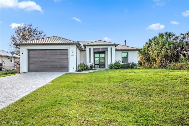 view of front of house with a garage and a front yard