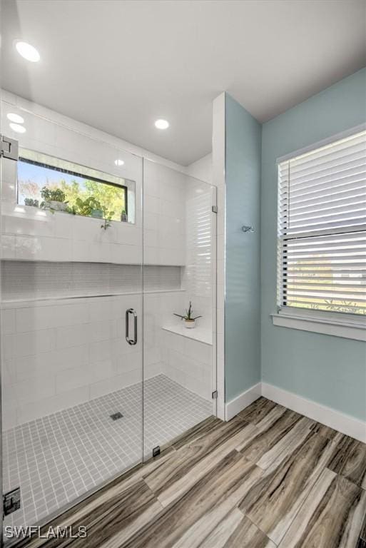 bathroom featuring an enclosed shower and wood-type flooring