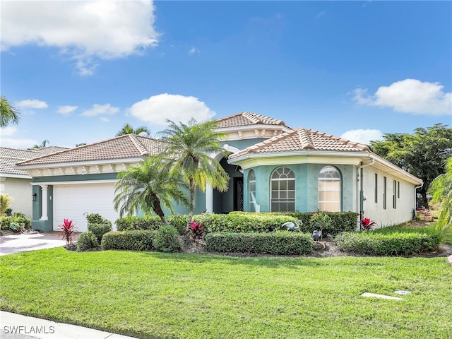 mediterranean / spanish-style home with a garage and a front yard