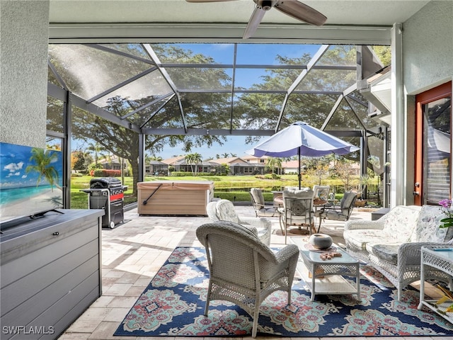 view of patio / terrace with a hot tub, grilling area, a lanai, and ceiling fan